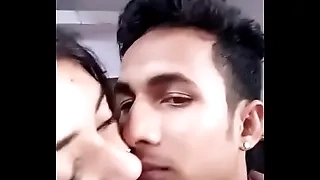 Girlfriend boyfriend kissing in a room
